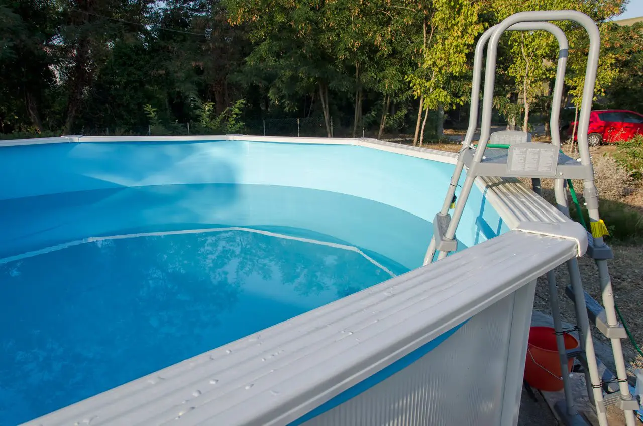 A pool with a ladder on the side of it