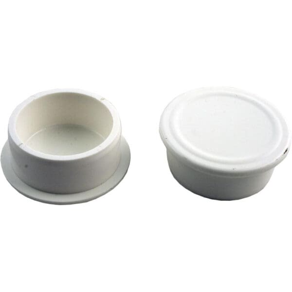 Two white plastic caps, one open.