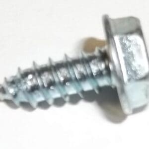 Metal screw with hexagonal head on table.