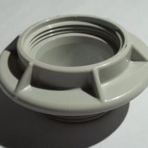 Plastic threaded pipe fitting on white background.