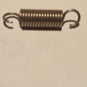 Metal coil spring on a plain surface.