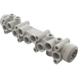 Plastic manifold with multiple pipe connections.