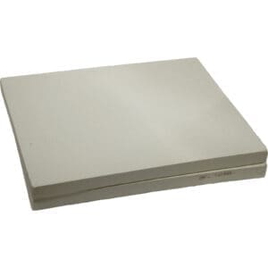 Stacked rectangular ceramic kiln shelves.