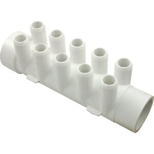 White plastic irrigation manifold with multiple outlets.