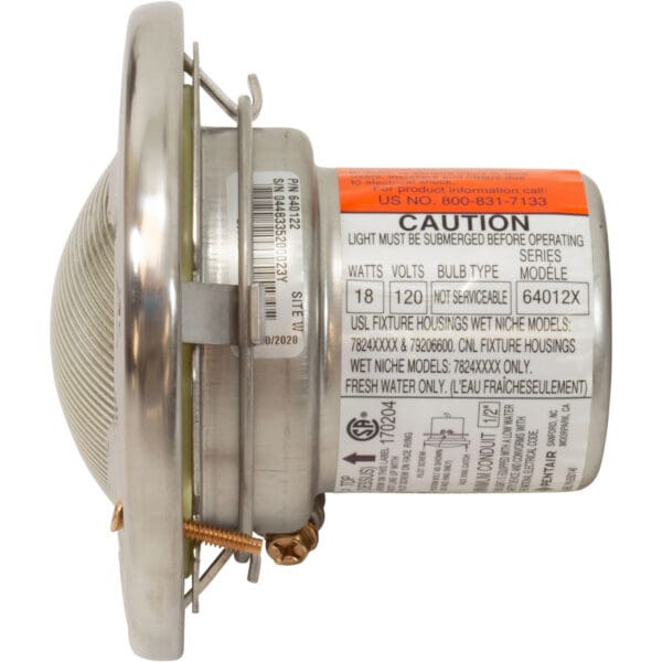 Underwater pool light with caution labels.