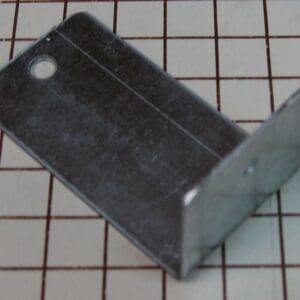 Metal bracket on a grid background.