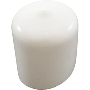 White cylindrical candle against plain background.