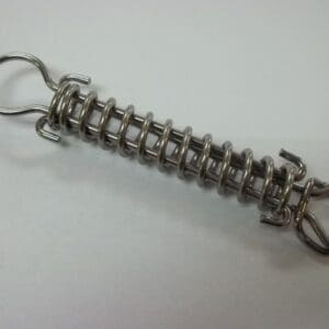 Metal tension spring with hooks on ends.