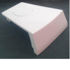 White plastic door stopper on surface.