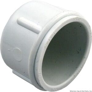 White PVC slip cap pipe fitting.