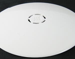 White round plastic vent cover on black background.
