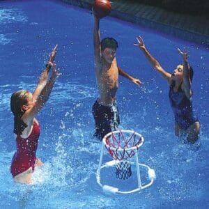 Kids playing basketball in a swimming pool.